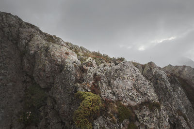 Low angle view of rock formation against sky