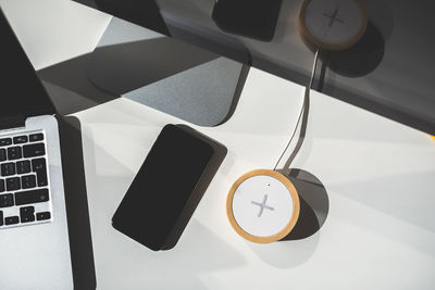 Close-up of mobile phone with charger on table