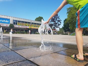 Water splashing in fountain against clear sky