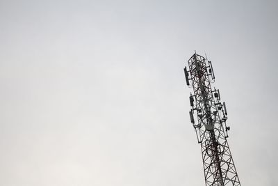 Low angle view of communications tower against sky