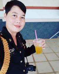 Portrait of smiling man holding drink
