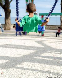 Rear view of children playing on playground