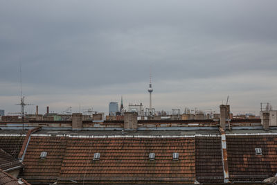 Buildings against cloudy sky