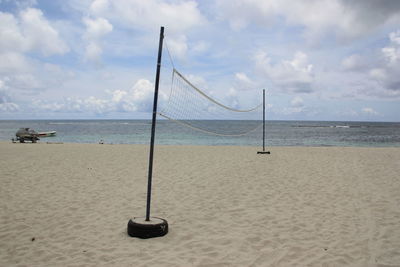View of swing on beach against sky