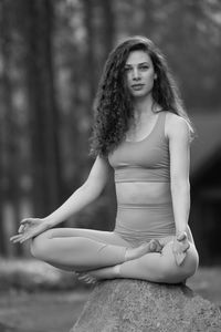 Young woman sitting on field