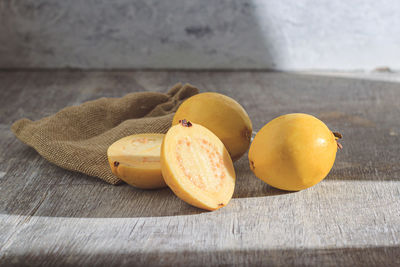 Yellow guava on wooden background. vitamin c, healthy fruit diet.