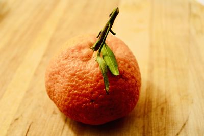 Single orange fruit on table
