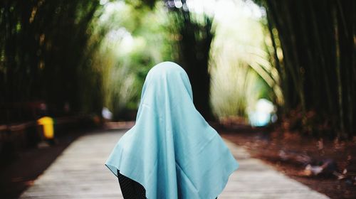 Rear view of woman wearing hijab while standing in park