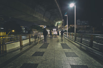 Man in illuminated city at night