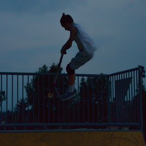 Full length of man skateboarding on railing against sky