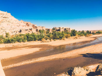 Scenic view of desert against clear blue sky