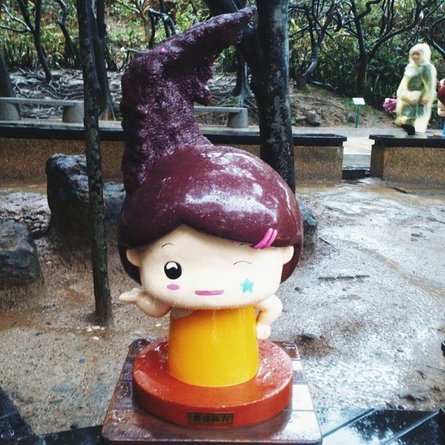 tree, creativity, art, human representation, childhood, art and craft, red, day, animal representation, outdoors, front or back yard, anthropomorphic face, park - man made space, sunlight, toy, tradition, celebration, close-up, decoration, sculpture