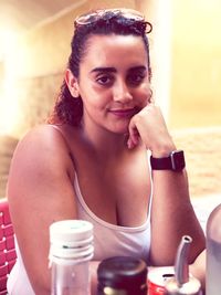 Portrait of smiling young woman sitting at table