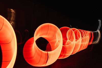 Close-up of illuminated lanterns over black background