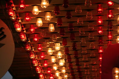 Low angle view of illuminated lanterns hanging at night