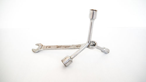 High angle view of cross on table against white background