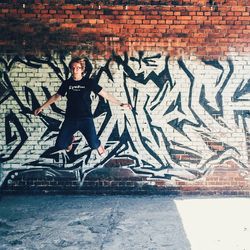 Full length of woman standing on wall