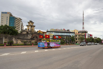 Vehicles on road against buildings in city