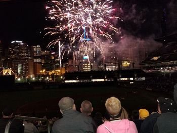 Rear view of firework display at night