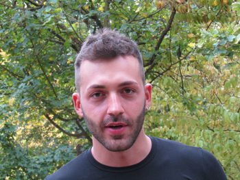 Portrait of young man against plants