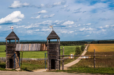 Built structure on field against sky