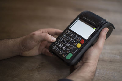 Midsection of man using mobile phone