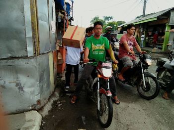 People on motorcycle against sky