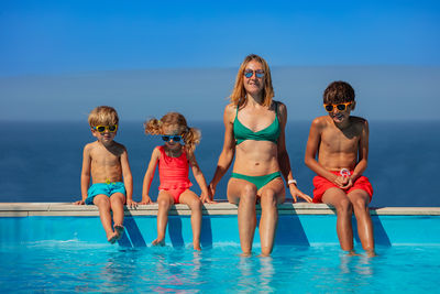 Rear view of friends in swimming pool