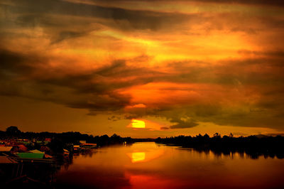 Scenic view of lake against orange sky