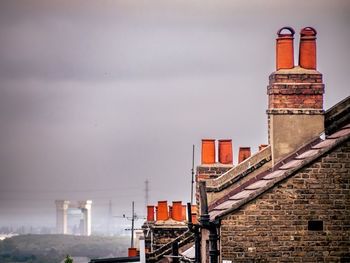 Terracotta chimney pots against a gloomy sky