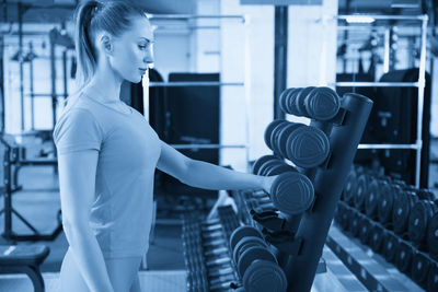 Young woman exercising in gym