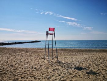 Lifeguard hut on beach against sky