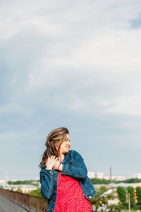 Happy girl standing against sky