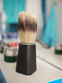 Close-up of shaving brush in bathroom