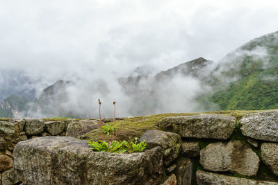 Scenic view of mountains against cloudy sky