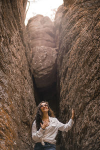 Low angle view of woman standing on rock