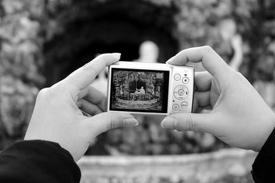 Cropped image of hand holding smart phone