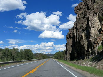 Empty road with mountain range in background