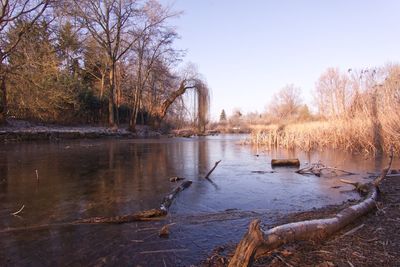 Scenic view of lake against sky during winter