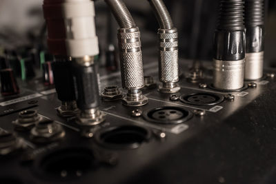 Close-up of jacks connected to sound mixer in recording studio