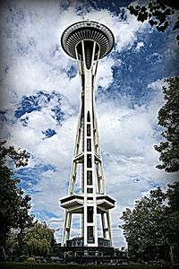 Low angle view of tower against cloudy sky