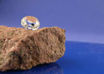 Close-up of rock against blue sky