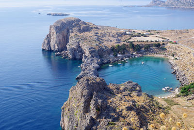 High angle view of rocks by sea against sky