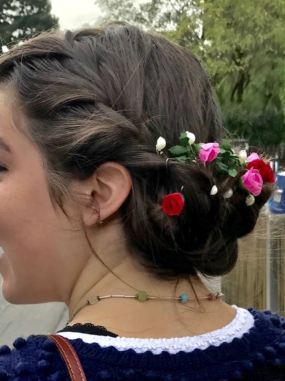 REAR VIEW OF YOUNG WOMAN WITH FLOWERS IN HAIR