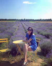 Full length of woman sitting on field