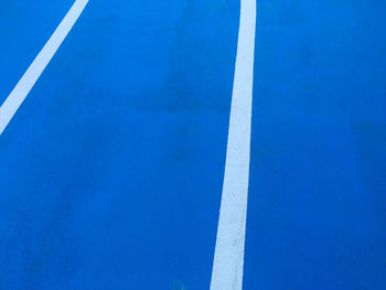 High angle view of empty road against blue sky