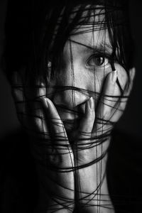 Close-up portrait of woman wrapped in string