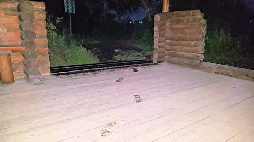 Brick wall with house in background