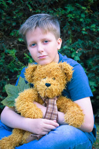 Portrait of boy holding toy