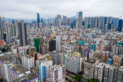 Aerial view of modern buildings in city against sky